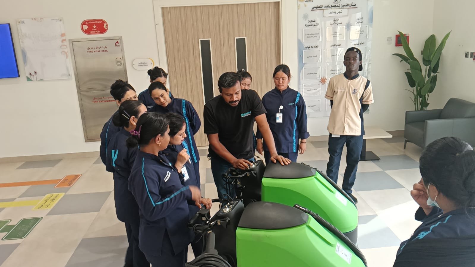 The company team explaining cleaning machine controls to operators on site